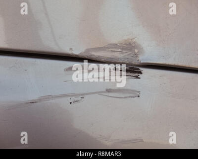 Scratches scrapes dings and dents on car damaged in accident Stock Photo