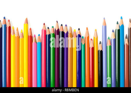 Colored pencils in a row on white background. Stock Photo