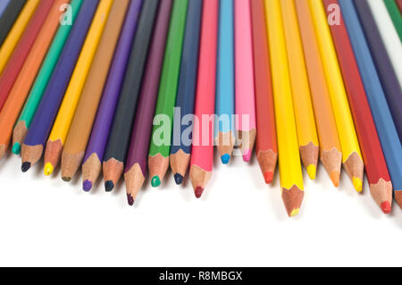 Colored pencils in a row on white background. Stock Photo