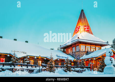 Rovaniemi, Finland - March 5, 2017: Santa Claus Office and Snowman at Santa Village with Christmas trees, Lapland. Finland, on Arctic Circle in winter. Stock Photo