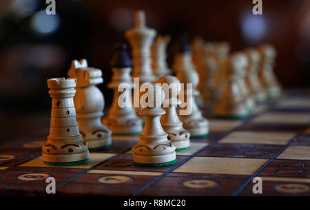 Close up white chess pieces on wooden board, low angle view Stock Photo