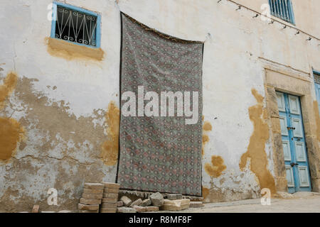 Old house in Tunis, Tunisia, Africa. The main entrance is covered by a big piece of cloth. Stock Photo