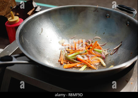 roasting vegetables in a wok pan. Street food. Asiasn food Stock Photo