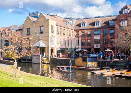 Cambridge, UK -  October 2018. Scudamore's Quayside Punting Station with tourists punting on the river Cam, view from with Magdalene College garden. Stock Photo