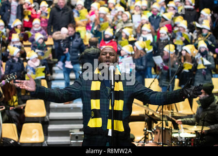 Dortmund, Germany. 16th Dec, 2018. Opera singer Mandla Mndebele sings the soccer hymns 'You never walk alone' at the Signal Iduna Park, Germany's biggest Christmas song according to the organizers. 50,000 singers were expected in the BVB stadium. Credit: Bernd Thissen/dpa/Alamy Live News