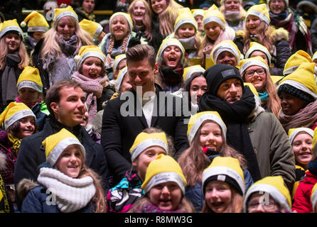 Dortmund, Germany. 16th Dec, 2018. The BVB players Mario Götze, Lukasz Piszczek and Marco Reus (l-r) stand between members of the WDR children's choir of the Dortmund Choir Academy at the largest Christmas singing in Germany in Signal Iduna Park, according to the organisers. 50,000 singers were expected in the BVB stadium. Credit: Bernd Thissen/dpa/Alamy Live News