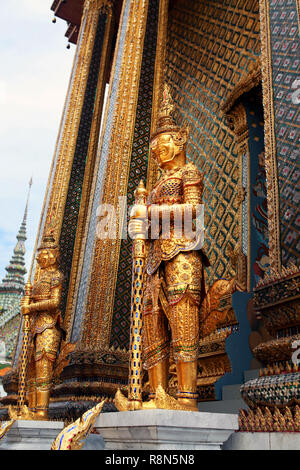 Statue of the golden guard at an entrance to the Phra Mondop temple Stock Photo