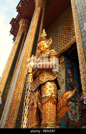 Statue of the golden guard at an entrance to the Phra Mondop temple Stock Photo