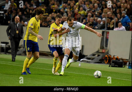 Solna, Sweden - November 20, 2018. Sweden national team players Mikael Lustig and Victor Lindelof against Russia national team striker Artem Dzyuba du Stock Photo