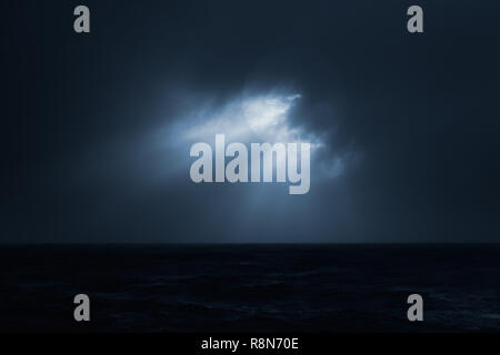 Dark overcast sea full moon night before storm. Used digital filter. Stock Photo