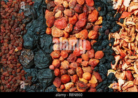 Healthy food. Background of dried fruit. Rows of dried apricots, pears, raisins, apples, prunes Stock Photo