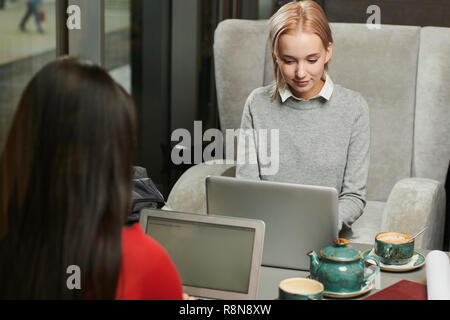 Freelancers working in cafe Stock Photo