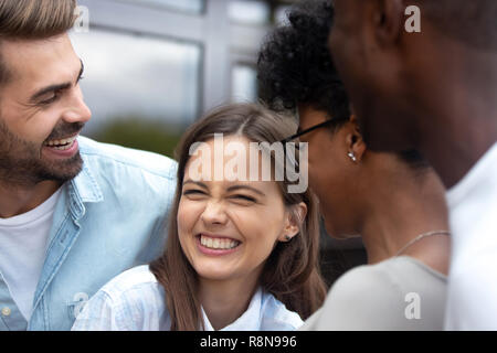 Young happy woman laughing at joke with friends close up Stock Photo