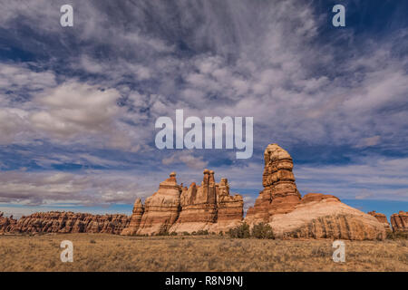 Dramatic clouds above colorful sandstone formations along the Chesler Park Loop Trail in the Needles District of Canyonlands National Park, Utah, Octo Stock Photo