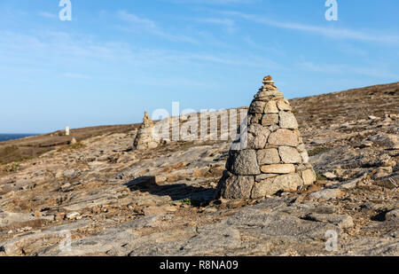 Cairn, piles of stones on the coast of Port Guibello in Saint-Pierre Quiberon (Morbihan, France) Stock Photo