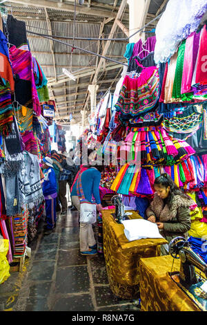 Seamstress sewing, traditional alpaca and Peruvian textiles and clothing at San Pedro market in Cusco, Sacred Valley, Peru Stock Photo