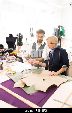 Two Tailors Working in Atelier Stock Photo
