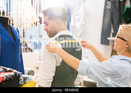 Man Getting Fitted for Jacket Stock Photo