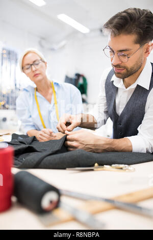 suit jacket on male tailor mannequin and sewing tools, creative concept ...