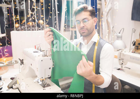 Male Tailor Sewing at Machine Stock Photo