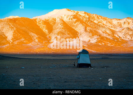 Light of sunset shine on the the beautiful snow mountain in the evening Stock Photo