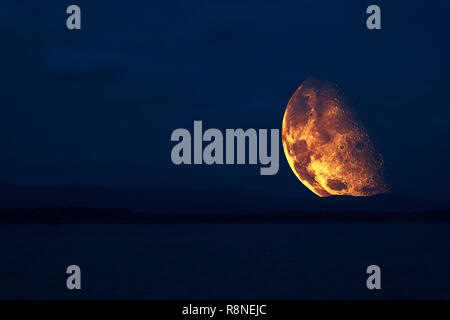 half moon floating in sky back on silhouette mountain ,Elements of this image furnished by NASA Stock Photo