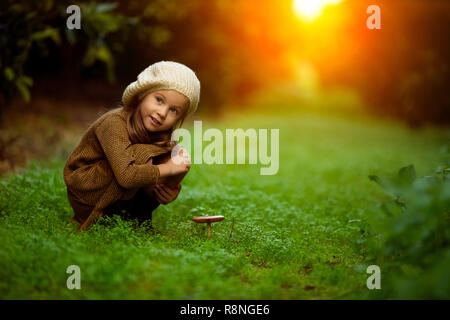 Adorable little girl hiking in the forest on summer day Stock Photo