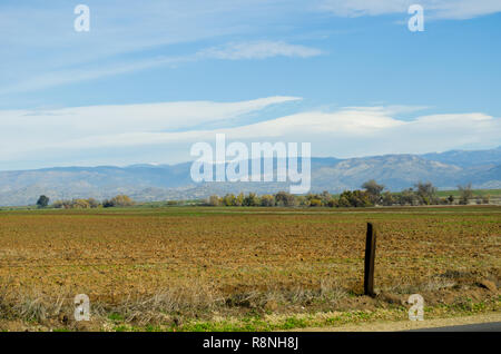 Lenticular clouds over the Sierra Nevada mountains, from the central Valley, Fresno California USA Stock Photo