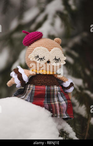 SYKTYVKAR, RUSSIA - DECEMBER 16, 2018: Illustrative image. Sleeping owl toy knitted in the technique of knitting amigurumi Stock Photo