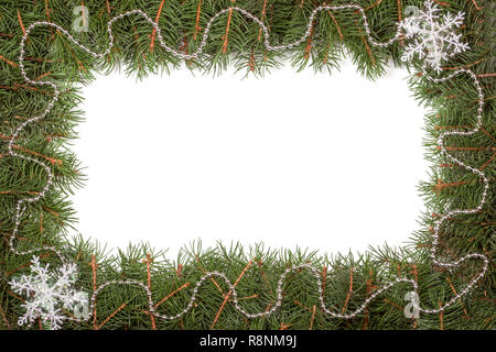 Christmas frame made of fir branches decorated with beads and snowflake isolated on white background Stock Photo