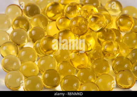 a bunch of fish oil capsules as background Stock Photo