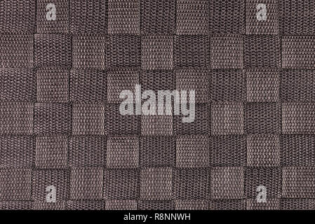 Real, brown knitted fabric fragment made of synthetic fibres textured background, with delicate pattern. Stock Photo