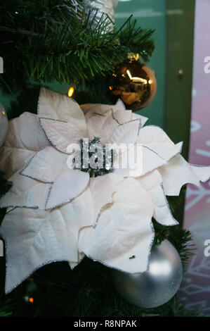 Decorative toy on the Christmas tree in the form of a white textile flower Stock Photo