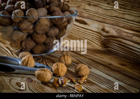 Walnuts are on the wooden table next to a Walnuts of Nuts Stock Photo