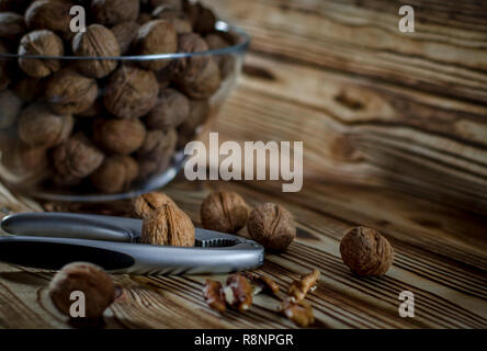 Walnuts are on the wooden table next to a Walnuts of Nuts Stock Photo