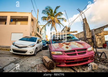 Unwanted car scrap on the street left abandoned Stock Photo