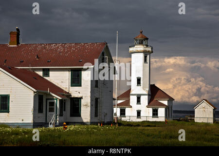 WASHINGTON - Thunderstorm brewing across Admirilty Inlet from the abandoned Point Wilson Lighthouse at Fort Worden State Park in Port Townsend. Stock Photo