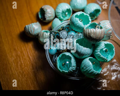 Hand made coral colorful beaded necklace. Expertly crafted beautiful original beads from polymeric hand-worked clay on the wooden table. Stock Photo