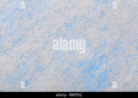 Structure of white background with blue spots of felt fabric, closeup. Texture of woolen matt gray textile. Cloth backdrop. Stock Photo