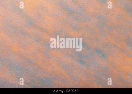 Structure of a light coral background with blue spots of felt fabric, closeup. Texture of woolen orange matt textile. Cloth backdrop. Stock Photo