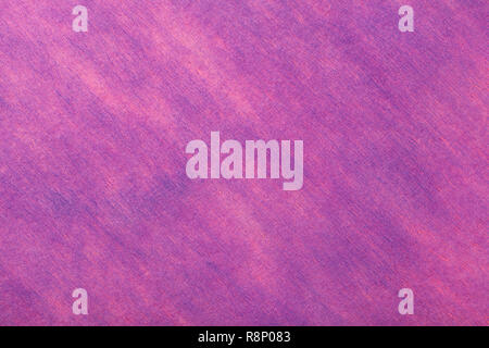 Structure of a light purple background with pink spots of felt fabric, closeup. Texture of woolen magenta matt textile. Cloth backdrop. Stock Photo