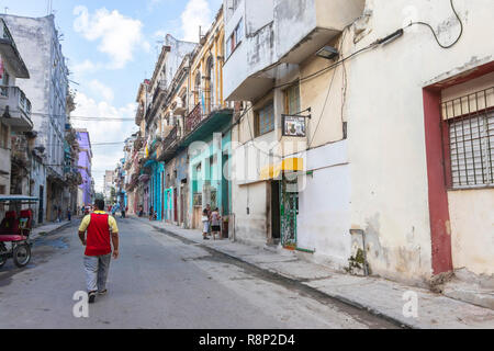 man walking down old street in Havana Cuba Stock Photo