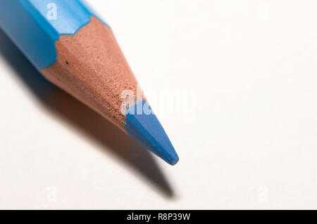 Macro of a blue color pencil, isolated on white paper. Stock Photo