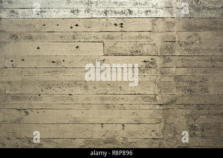 A striped silver gold colored concrete wall Stock Photo