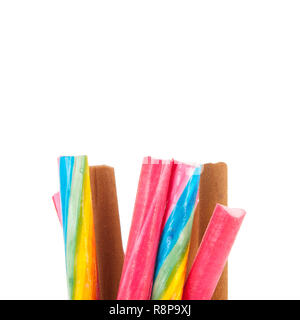 Glass pot of colorful candy canes isolated over white background Stock Photo