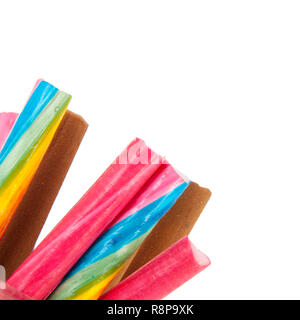 Glass pot of colorful candy canes isolated over white background Stock Photo