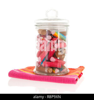 Glass pot of colorful candy canes isolated over white background Stock Photo
