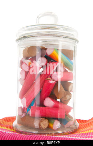 Glass pot of colorful candy canes isolated over white background Stock Photo