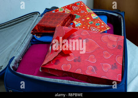Return to the family home for the Christmas holidays, with a suitcase full of presents. Stock Photo