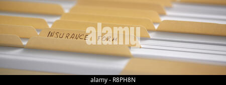 Yellow folders with labels and paper in a row Stock Photo